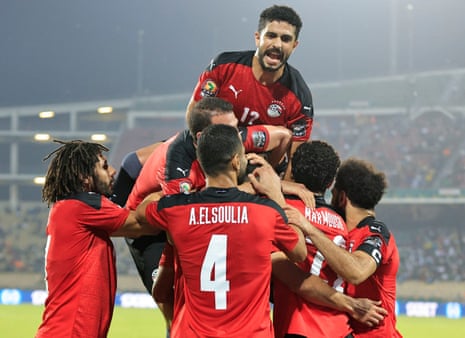 Egypt’s Mohamed Abdelmonem celebrates scoring their first goal with teammates.