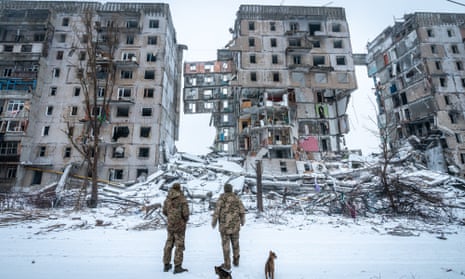 Ukrainian soldiers in front of a building destroyed by a Russian rocket attack in Donetsk.