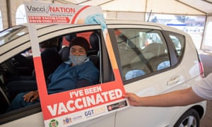 A person has her vaccine administered at a drive through Covid-19 coronavirus vaccination site at the Swartkops Raceway in Pretoria, South Africa, 18 August 2021. South Africa has to date vaccinated 17 percent of the population and is aiming at starting vaccinations for over 18 year olds in the next weeks. EPA/KIM LUDBROOK