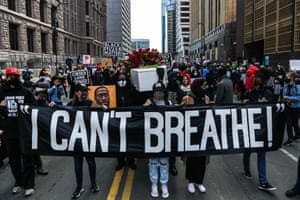 Demonstrators hold placards during the I Cant Breathe - Silent March for Justice, the day before the trial of former Minneapolis police officer Derek Chauvin, charged with murdering George Floyd, in Minnesota. Since his brutal death George Floyd has embodied, more than any other, the black victims of police racist violence in the US