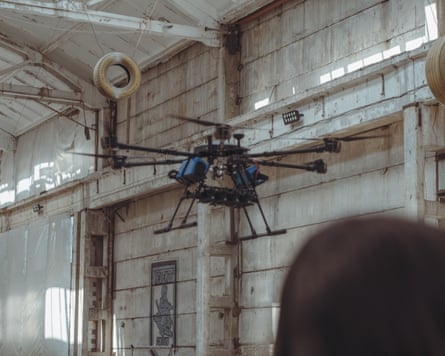 A drone hovers inside a warehouse