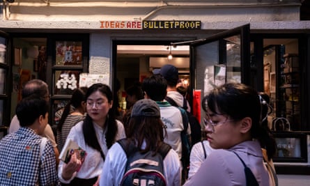 A sign reading ‘IDEAS ARE BULLETPROOF’ is seen as visitors browse books on the last day of business of independent bookshop Mount Zero in Hong Kong
