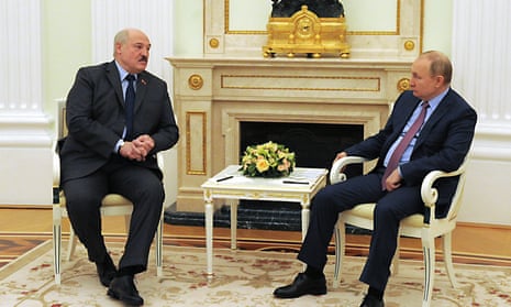 Vladimir Putin, right, and Alexander Lukashenko talk during their meeting in the Kremlin