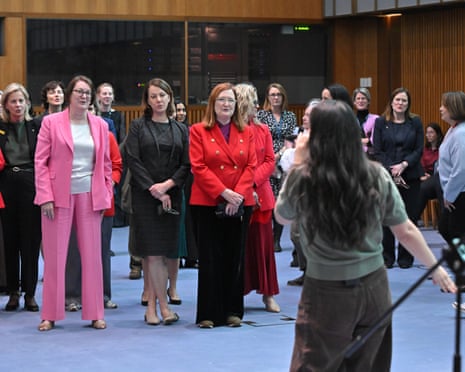 Parliamentarians including Liberal frontbencher Angie Bell, Labor MPs Susan Templeman and Louise Miller-Frost, and independent MP Sophie Scamps sing.