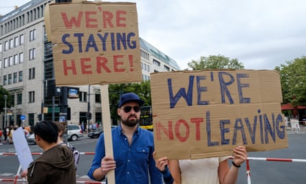 Britons hold up signs as they demonstrate against Brexit in Berlin.