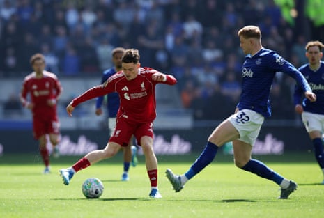 Florian Wirtz of Liverpool (L) in action against Jarrad Branthwaite of Everton (R).