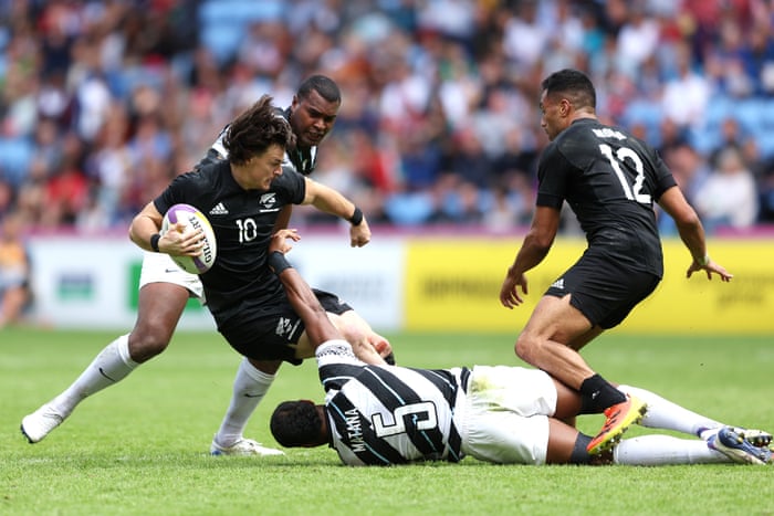 Leroy Carter of New Zealand is tackled by Jeremaia Matana of Fiji.