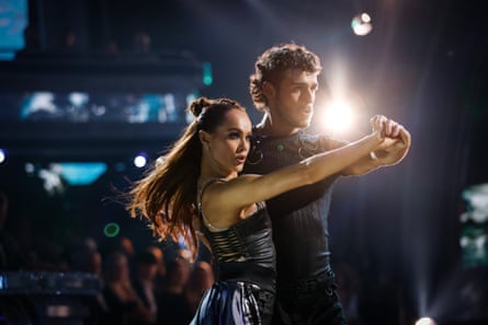 Alexis Warr and George Clarke strike a dance pose dressed in black