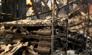 Burnedout wine bottles sit on a rack at the fire damaged Signarello Estate winery.