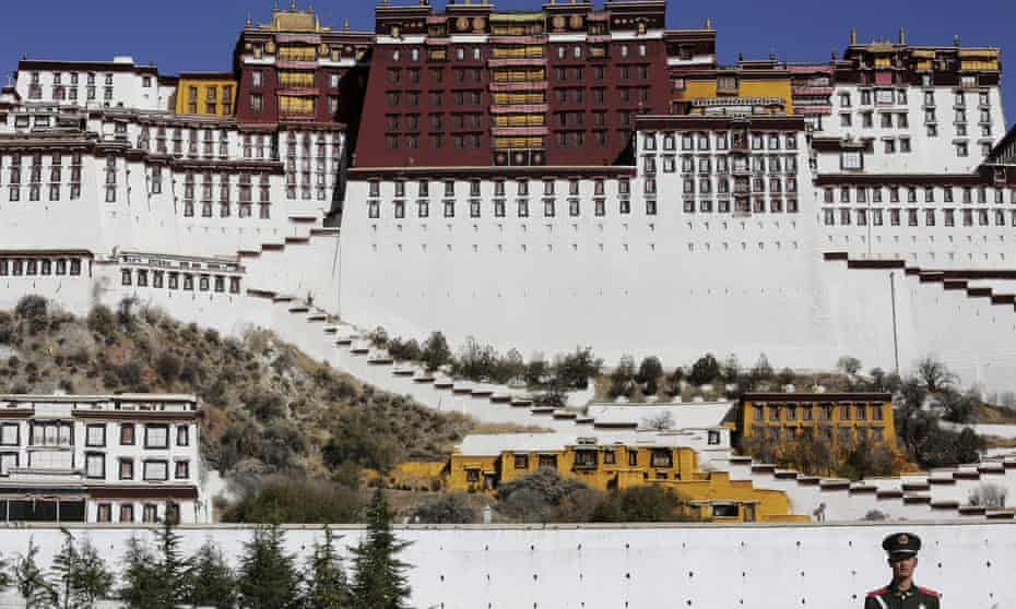 A paramilitary policeman stands guard in front of the Potala Palace in Lhasa, Tibet