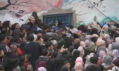 Unrwa distributed flour to Palestinians in Gaza, where there is a food crisis<br>GAZA CITY, GAZA - MARCH 18: Palestinians wait in front of the United Nations (UN) Relief and Works Agency for Palestine Refugees in the Near East (UNRWA) distribution center to receive a limited amount of flour as Israeli attacks continue on Gaza City, Gaza on March 18, 2024. While the Israeli army has been continuously attacking the Gaza Strip, where approximately 2.3 million Palestinians live since October 7, 2023, it does not allow humanitarian aid to enter the region it has completely blockaded. Hundreds of thousands of people are struggling with hunger in the Gaza Strip, where basic food products have run out due to the Israeli bombardment and complete blockade that has been going on for about 6 months. (Photo by Mahmoud Issa/Anadolu via Getty Images)
