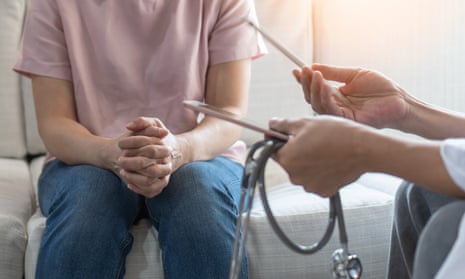 Woman speaking to doctor while sat on a sofa