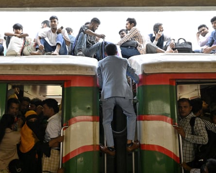 People board an overcrowded train