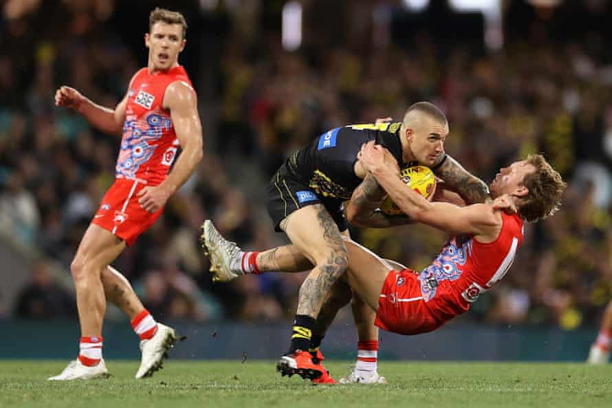 Richmond’s Dustin Martin is tackled by Callum Mills of the Swans.