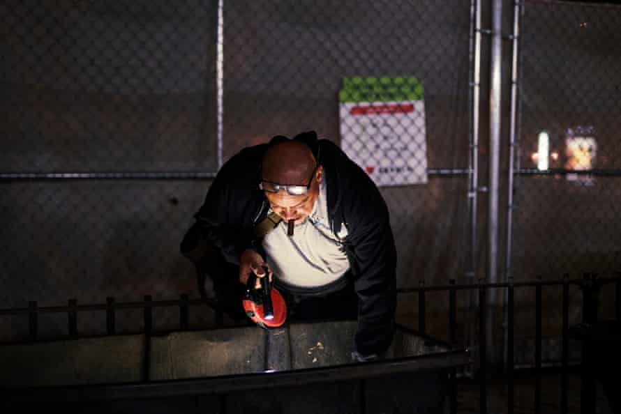 Greg Concepcion and members of the group of Rats, comb through a garbage bin in the Lower East Side.