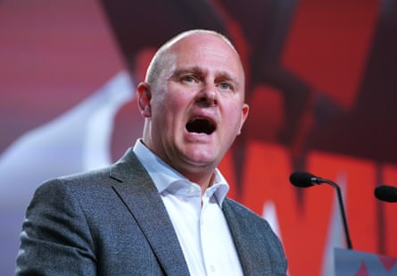 Paul Nowak speaking on stage at a conference