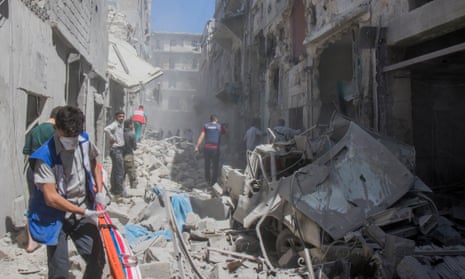Emergency workers after an airstrike hit a civilian neighbourhood in eastern Aleppo, wounding three.