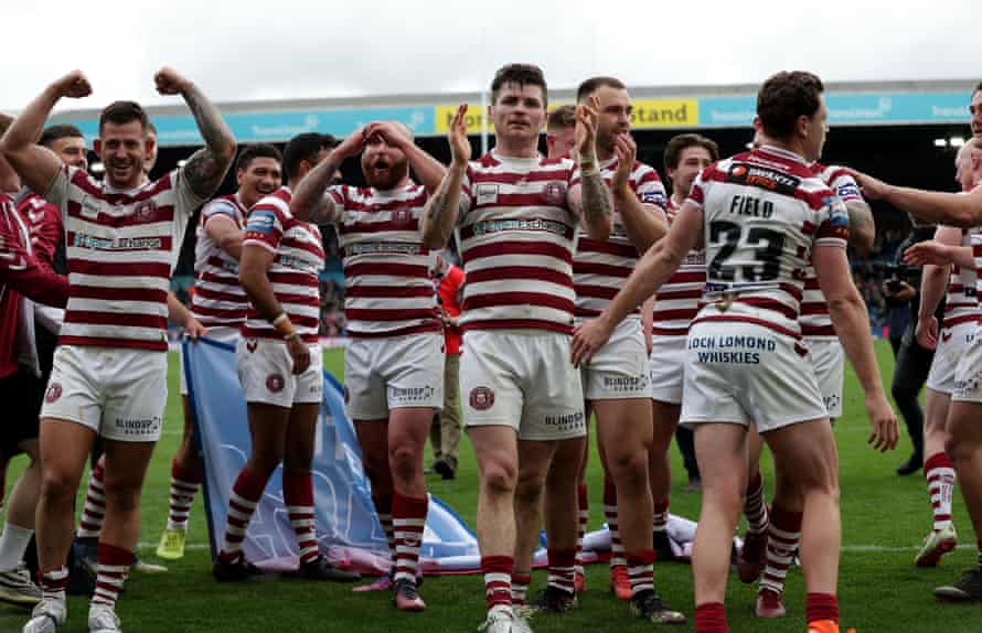 Wigan players celebrate after reaching the Challenge Cup final.