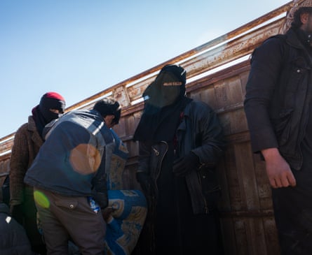 Suspected Isis families are seen inside a truck that will transport them to an IDP camp after fleeing Baghuz