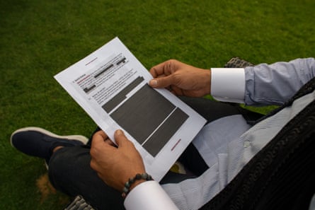 Khaled al-Hamedi holds a document while reading it