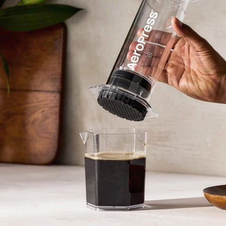 A person making coffee with an Aeropress XL and Clear XL