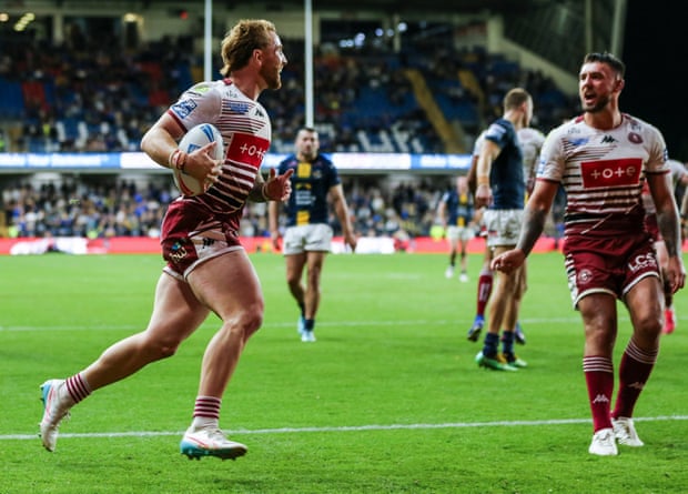 Adam Keighran of Wigan Warriors scores a try