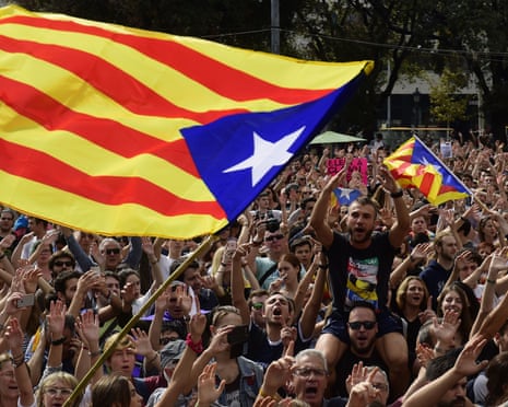 People shout slogans as they wave Catalan pro-independence ‘Estelada’ flags during a protest in Barcelona on 2 October 2017 a day after hundreds were injured in a police crackdown during Catalonia’s banned independence referendum.