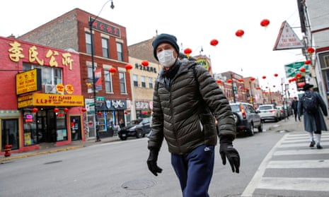 A man wears a masks in Chinatown in Chicago, Illinois.