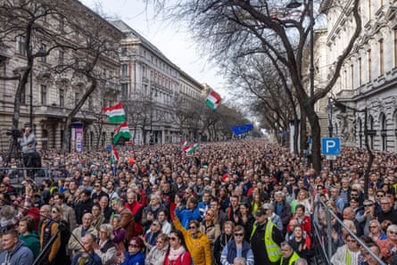 Supporters of Peter Magyar look on as he speaks at an opposition demonstration on Andrassy Avenue in Budapest