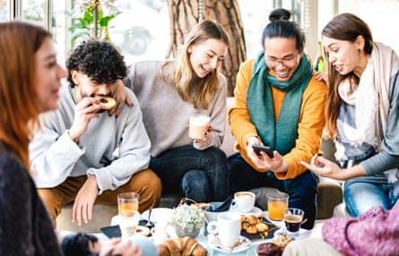 Friends having coffee and pastries in a cafe