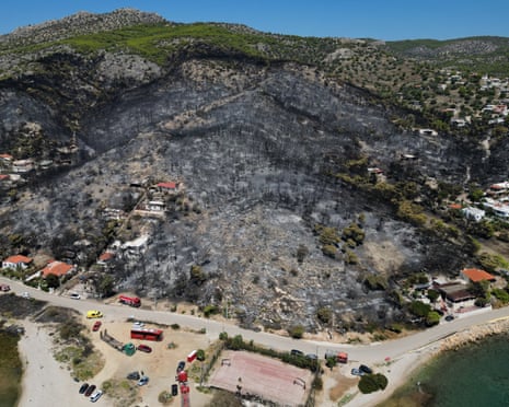 A view from a burned area a day after a wildfire in Peristeria village on the island of Salamina, west of Athens, Greece.
