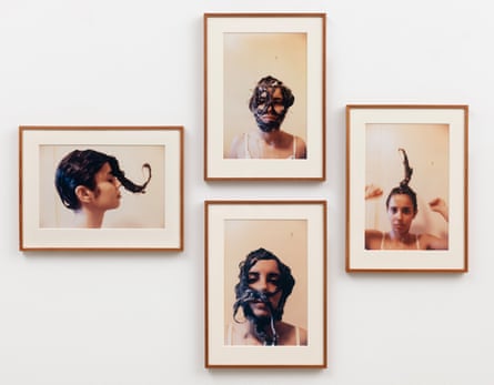 Four framed portraits on the wall of a gallery