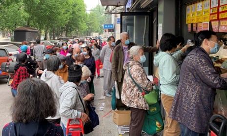 Beijing residents line up for food supplies from a grocery store following reports of 19 new Covid cases in the Chinese capital on Monday. 