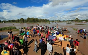 Residents gather on the safe grounds with their belongings after the River Nzoia burst its banks in Busia County, Kenya.