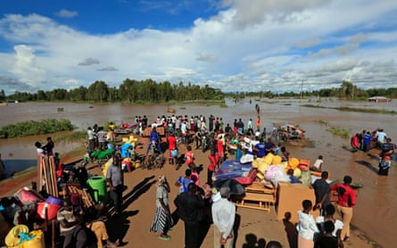 Residents gather on the safe grounds with their belongings after the River Nzoia burst its banks in Busia County, Kenya.
