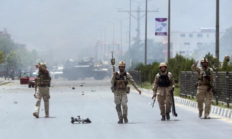 Afghan security forces inspect the site of a suicide attack during clashes with Taliban fighters in front of the Parliament, in Kabul, Afghanistan, Monday, June 22, 2015. 