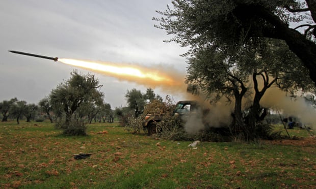 Members of Syria’s opposition National Liberation Front fire rockets at government forces in the village of Talhiyeh in north-eastern Idlib province.
