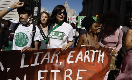US Stop Ecocide proponent Julia Jackson, center and in sunglasses, demonstrates in New York City on 23 September 2022.