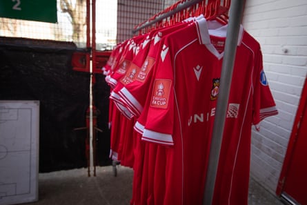 Replica Wrexham shirts with FA Cup branding stored outside the club shop.