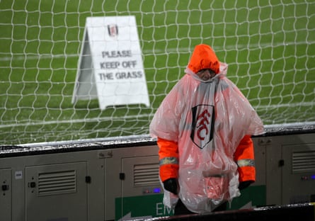 December 15: A steward in a rain poncho before the Premier League match at Craven Cottage between Fulham and West Ham United.
