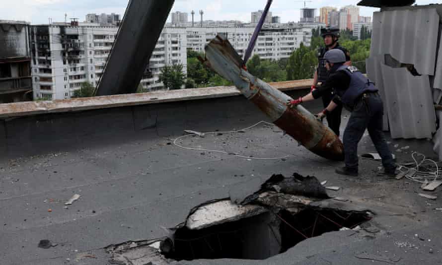 Munitions experts remove a defused 500kg bomb that did not detonate when it landed on an apartment building in March, in the Saltivka neighbourhood, in Kharkiv, Ukraine.