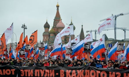 Russia’s opposition supporters carry a banner reading ‘These bullets in each of us’ during a march in memory of murdered Kremlin critic Boris Nemtsov in central Moscow