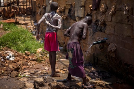 Homeless children shower in Kisenyi.