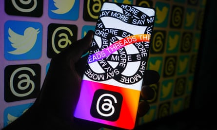 The Threads app is displayed on a mobile phone with Twitter and the Threads logo in the background