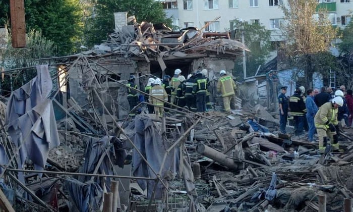 Rescue specialists work at the site of a destroyed residential building after the blasts in Belgorod, Russia, on Sunday