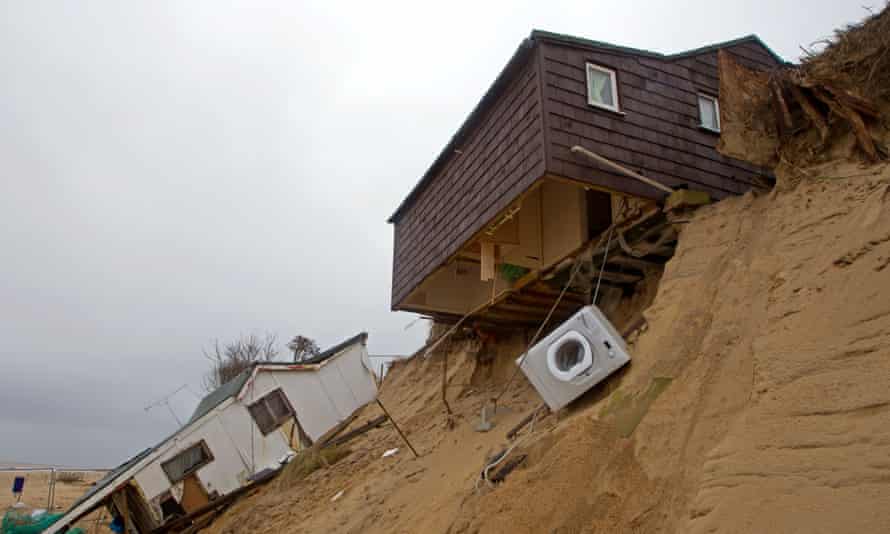Chalets teeter on the edge following tidal surges in Hemsby, Norfolk, in 2013