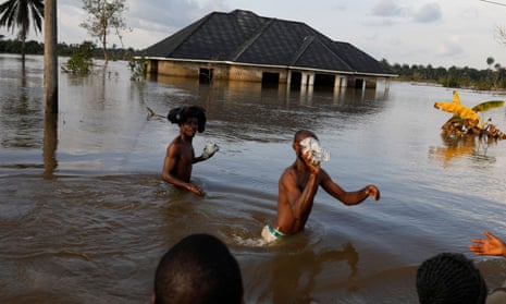 Residents wading through floodwater in Obagi in Rivers state, Nigeria in October