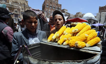 Yemeni children look at corn cobs for sale at a market in Sana’a but prices have soared amid supply issues.