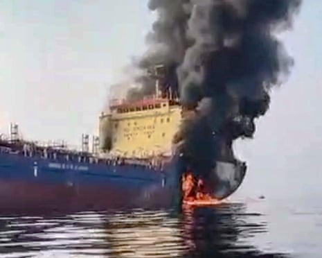 A video grab of a tanker with its stern on fire and black smoke billowing from it