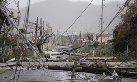 FILE - Electricity poles and lines lay toppled on the road after Hurricane Maria hit the eastern region of the island, in Humacao, Puerto Rico, Wednesday, Sept. 20, 2017. A U.S. report released Tuesday, June 1, 2021, has found that abstract emergency response guidelines for the Federal Communications Commission could have caused confusion and delays after Hurricane Maria devastated Puerto Rico and the U.S. Virgin Islands in 2017. (AP Photo/Carlos Giusti, File)